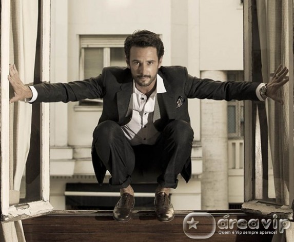 Rodrigo Santoro sobe no parapeito da janela de hotel para tirar foto