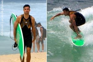 Cauã Reymond surfa em praia carioca