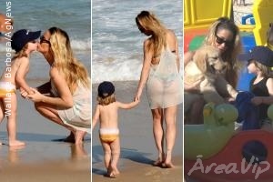 Danielle Winits brinca com o filho em praia carioca